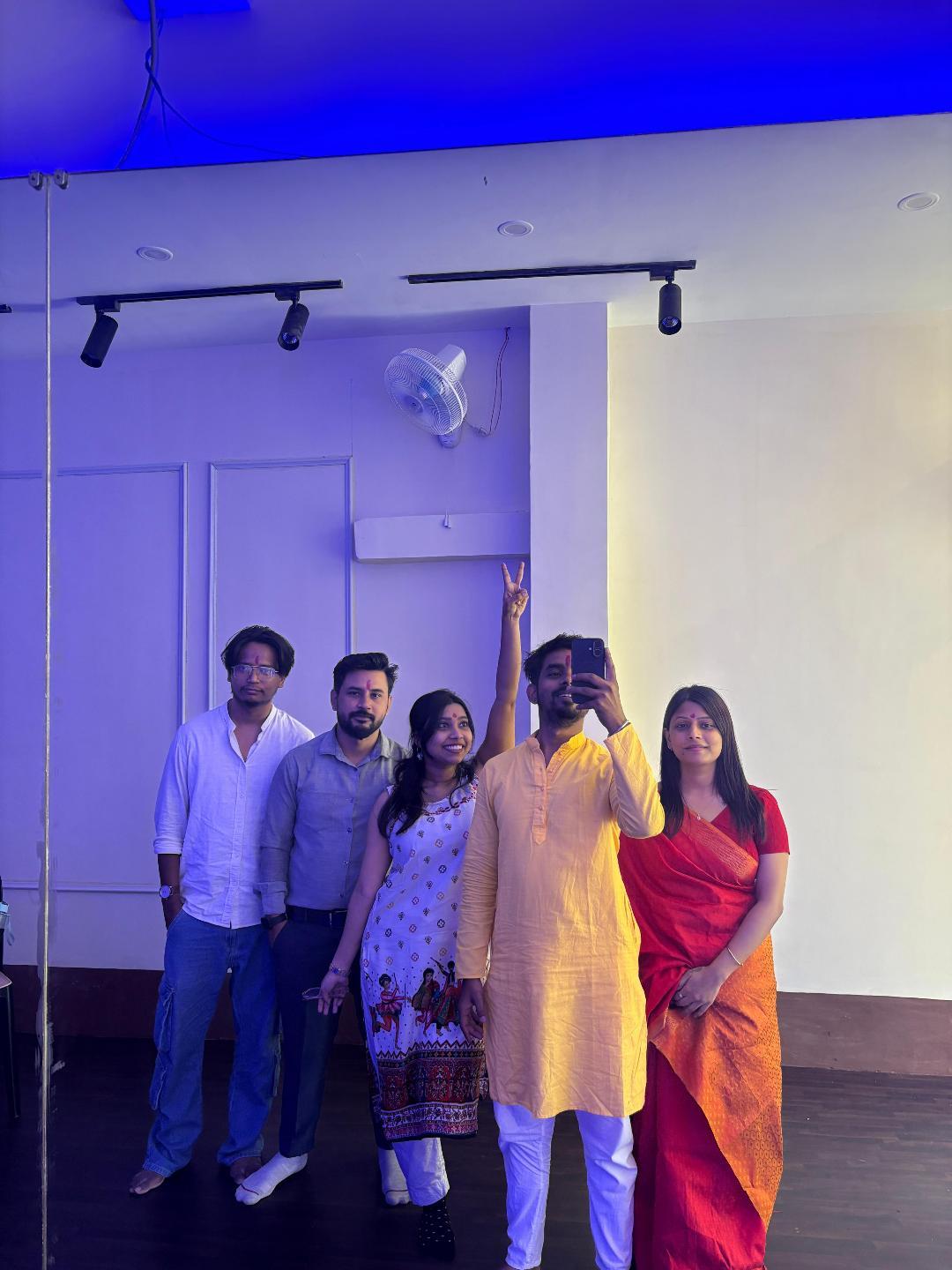 Netra family in festive kurtas and a saree celebrating together at the studio