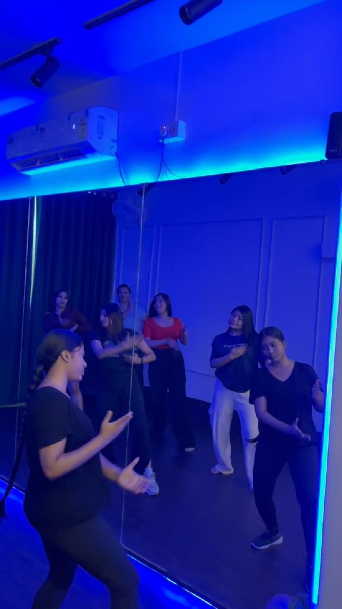 Zumba class following the routine in front of the mirror